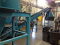 A grinder, feeder conveyors in a factory